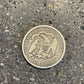 Seated Liberty Silver Half Dollar Coin back on a concrete background. - Mountainstruck Coin Jewelry